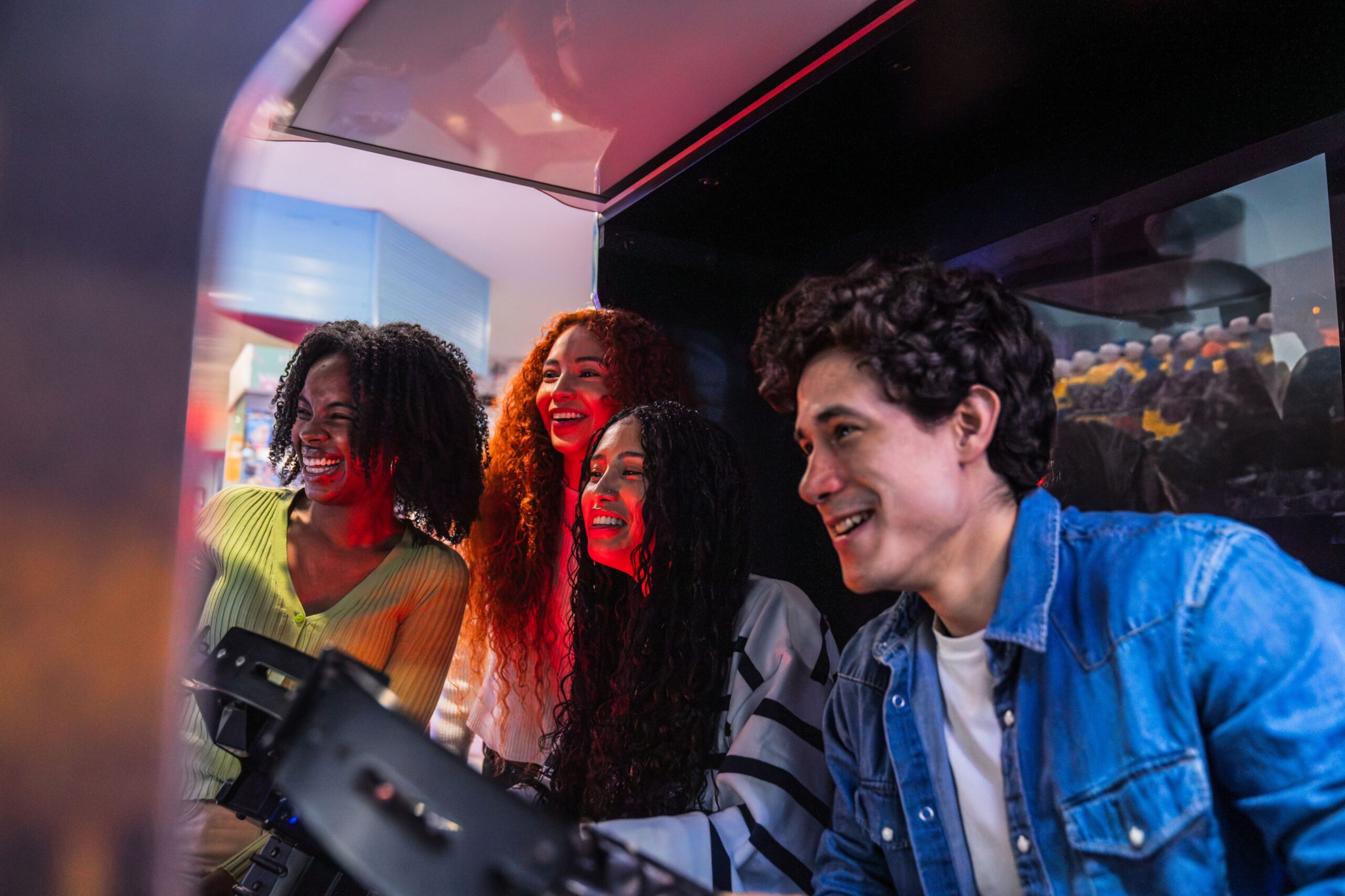 Group of young players laughing together while gaming on a Minecraft server in a multiplayer arcade environment